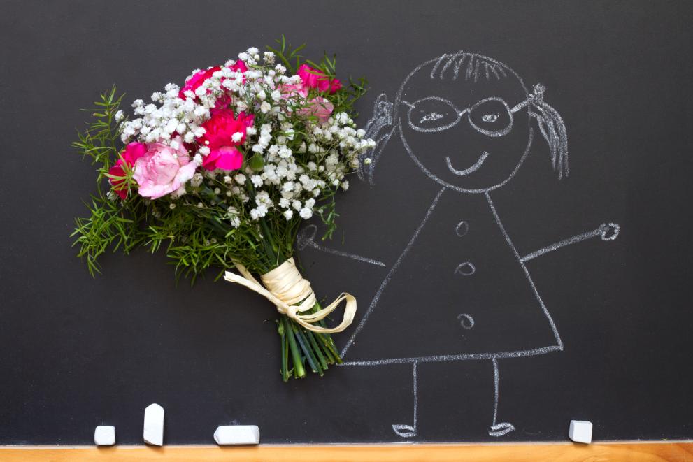 Girl with bouquet of flowers on blackboard 